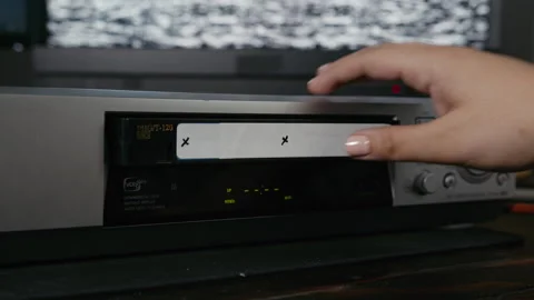 VHS Tape Inserted and Ejected from a VCR. Female Hand Motion Trackers VFX Plate Stock Footage 137442733