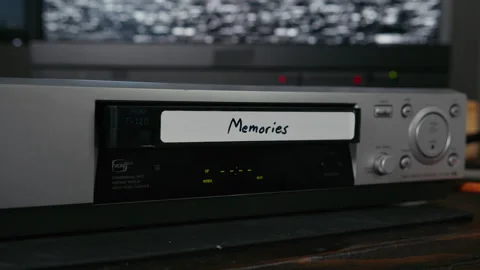 VHS Tape Inserted and Ejected from a VCR. Male Hand. Labeled "Memories" Stock Footage 137444560