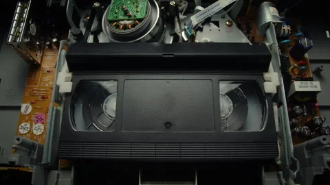 VHS Tape Inserted and Playing in a VCR Stock Footage 253973803