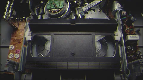 VHS Tape Inserted and Playing in a VCR Filter Stock Footage 253974593