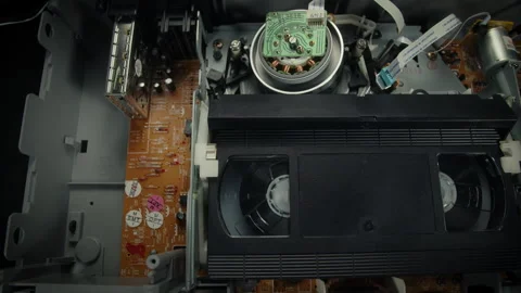 VHS Tape Inserted and Playing in a VCR Dolly Stock Footage 253974798