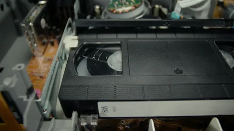 VHS Tape Playing in a VCR Angled Dolly Stock Footage 253973460