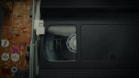 VHS Tape Playing in a VCR Close Up Dolly Stock Footage 253974641