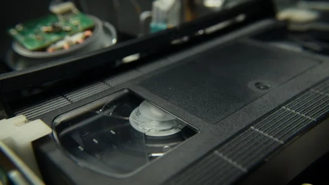 VHS Tape Playing in a VCR Diagonal Dolly Stock Footage 253972559