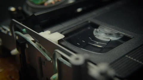 VHS Tape Playing in a VCR Diagonal Dolly Close Up Stock Footage 253973173