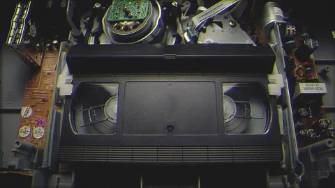 VHS Tape Playing in a VCR Filter Stock Footage 253974696