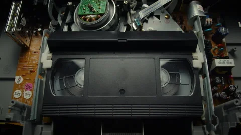 VHS Tape Playing in a VCR Stock Footage 253973966