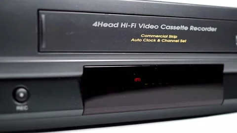 VHS VCR Deck with VHS Tape Being Inserted and Ejected Video stock 139737371