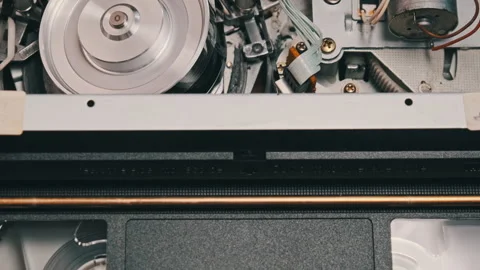 VHS Video Cassette Put Inside VCR Recorder and Playing Video stock 244369579