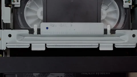 VHS video cassette recorder pull out from VCR player. Tape play video file or Video stock 218606059