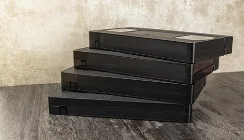 VHS video cassettes are stacked on top of each other. The concept of viewing Stock Photos