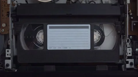 VHS Video Tape Playing in a VCR Machine Shown Up Close Video stock 314346669