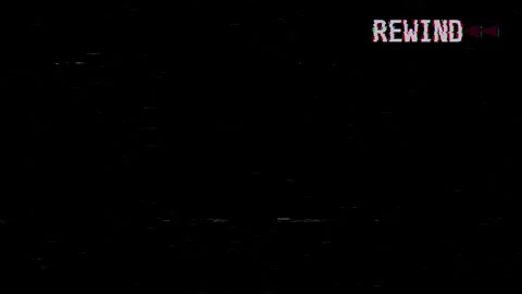A VHS video tape rewind screen on a black background displaying REWIND Stock Footage 333815816