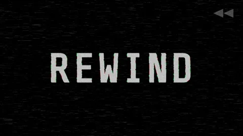 A VHS video tape rewind screen on a black background displaying REWIND Stock Footage 333816057