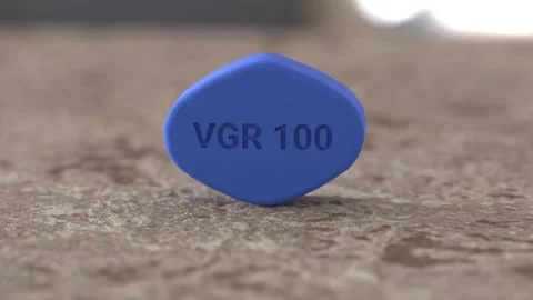 Viagra. Blue pill for erectile dysfunction treatment on table, close-up. 3d Stock Footage 257646383