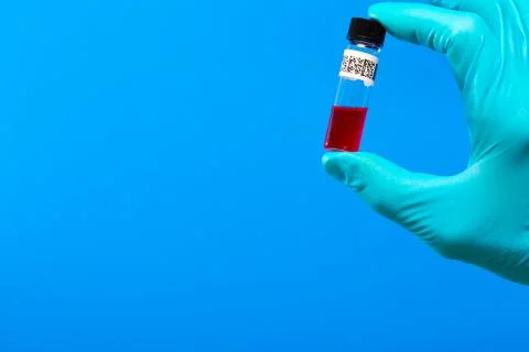 Vial QR code in hand with a glove Foto stock