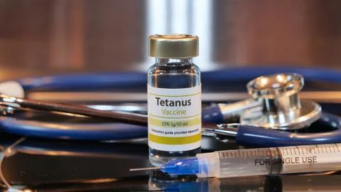 Vial of tetanus vaccine with syringe and stethoscope Stock Photos