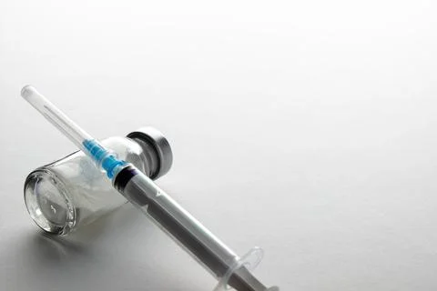 Vials and syringe on light table. Stock Photos