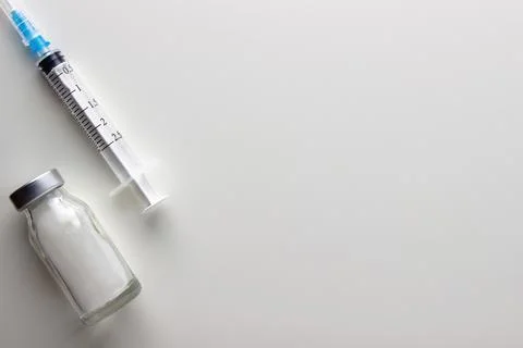 Vials and syringe on light table. Stock Photos