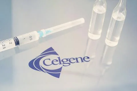 Vials of liquid on a white table and the logo of a large pharmaceutical compa Stock Photos