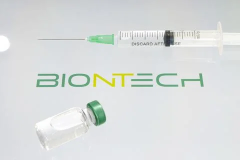 Vials of liquid on a white table and the logo biontech, large pharmaceutical  写真素材