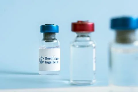 Vials of liquid on a white table and the logo Boehringer Ingelheim, large pha Stock Photos