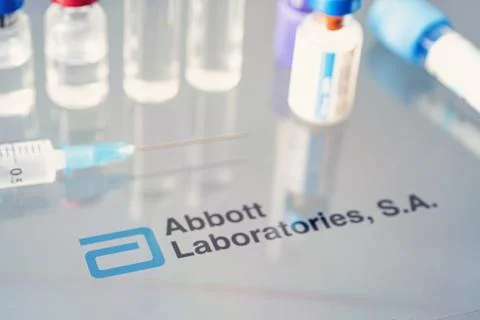 Vials of liquid on a white table and the logo Abbott Laboratories, large phar Stock Photos