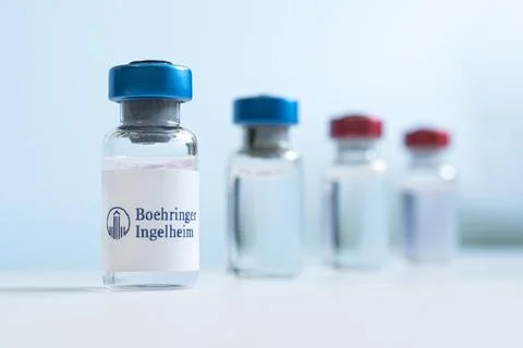 Vials of liquid on a white table and the logo Boehringer Ingelheim, large pha Stock Photos