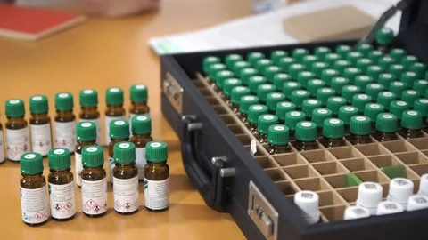 Vials on the table and in the suitcase. Medical vessels and cosmetic oil (Aroma) Stock Footage 85676152
