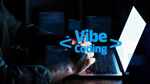 Vibe coding on a laptop at night with a focus on programming activities and Stock-Fotos