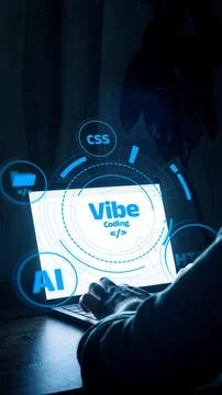 Vibe coding on a laptop with various tech icons displayed at night Stock Photos