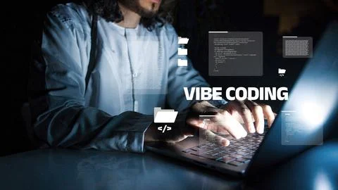 Vibe coding at night with a person using a laptop in a dark room 写真素材
