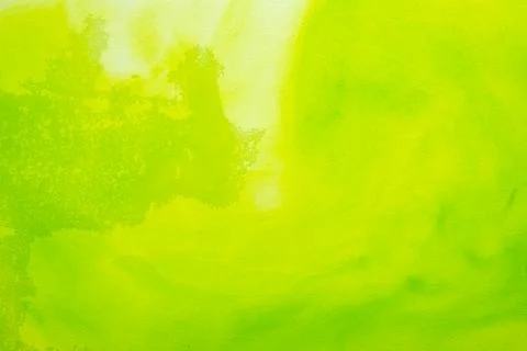 A vibrant abstract background featuring bright green and lime yellow ink or.. Stock Photos