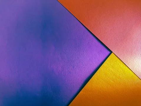 A vibrant abstract background with intersecting purple, orange, and gold pa.. Stock Photos