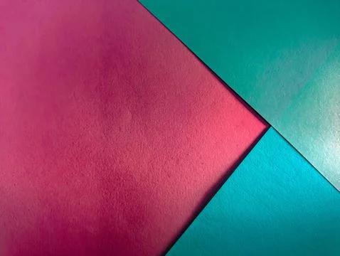 A vibrant abstract composition of overlapping pink and teal paper, creating.. Stock Photos