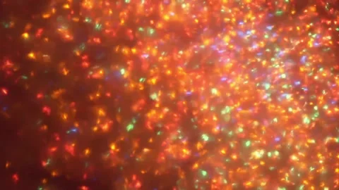 Vibrant abstract light particles swirling in motion. Dynamic glowing bokeh backg Видео 340450302