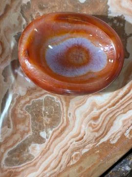Vibrant Agate Bowl with Eye Pattern on Onyx 스톡 사진