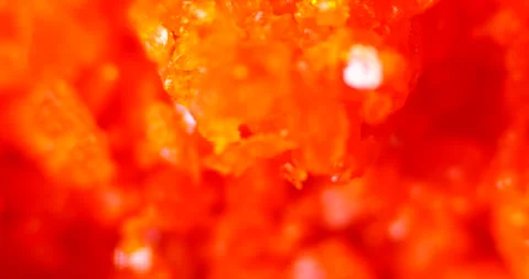 Vibrant ammonium dichromate crystals under microscope Stock Footage 308431561