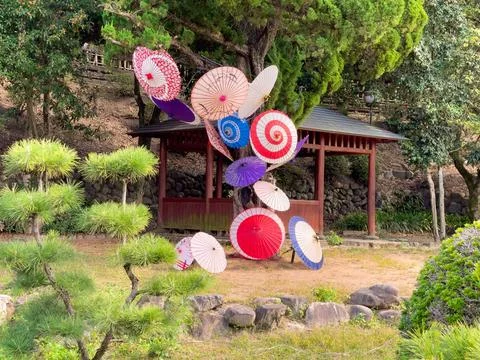 Vibrant and colorful array of umbrellas arranged in a green park in Japan Fotos de archivo