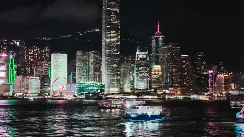 A vibrant and dynamic night scene of the Hong Kong skyline centered on the 库存影片 338280453