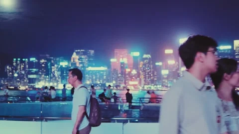 A vibrant and dynamic night scene in Hong Kong's Tsim Sha Tsui area with a Stock Footage 338280512