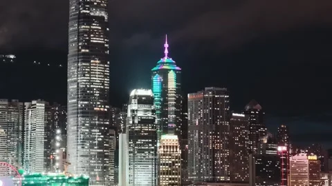A vibrant and dynamic night view of the Hong Kong skyline, featuring iconic Stock Footage 338280362