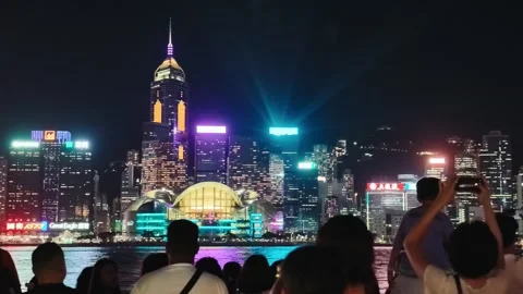 A vibrant and dynamic night view of Hong Kong's skyline from a waterfront Video stock 338280451