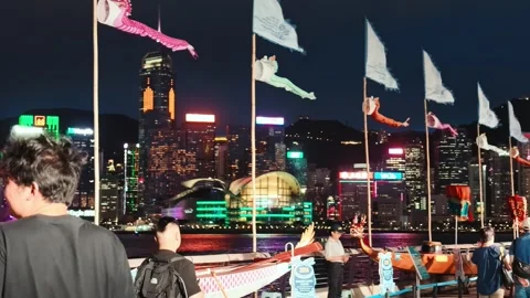 A vibrant and dynamic nighttime scene in Hong Kong's iconic Victoria Harbour, Stock Footage 338280351