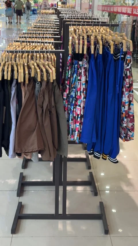 Vibrant Apparel Display Showcasing Diverse Garment Selections in a Modern R.. Video stock 326036846