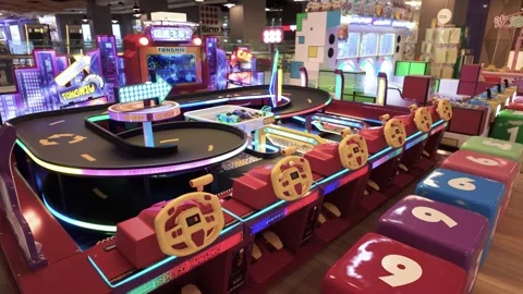 A vibrant arcade scene with a circular racing track. 動画素材 318132986