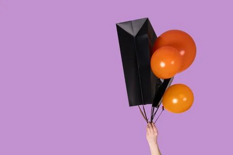 A vibrant array of colorful balloons with a beautifully wrapped gift box on a Stock Photos