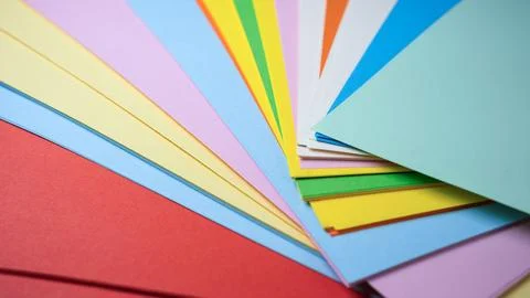 Vibrant array of colorful papers spread on a table for creativity Stock Photos