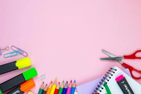 A vibrant array of colorful school supplies beautifully arranged on a pink .. Stock Photos