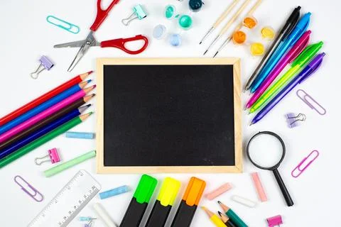 A vibrant array of colorful school supplies next to a chalkboard for creati.. Foto stock